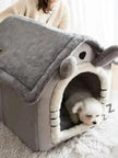 Dog lying in a gray pet house with a plush interior