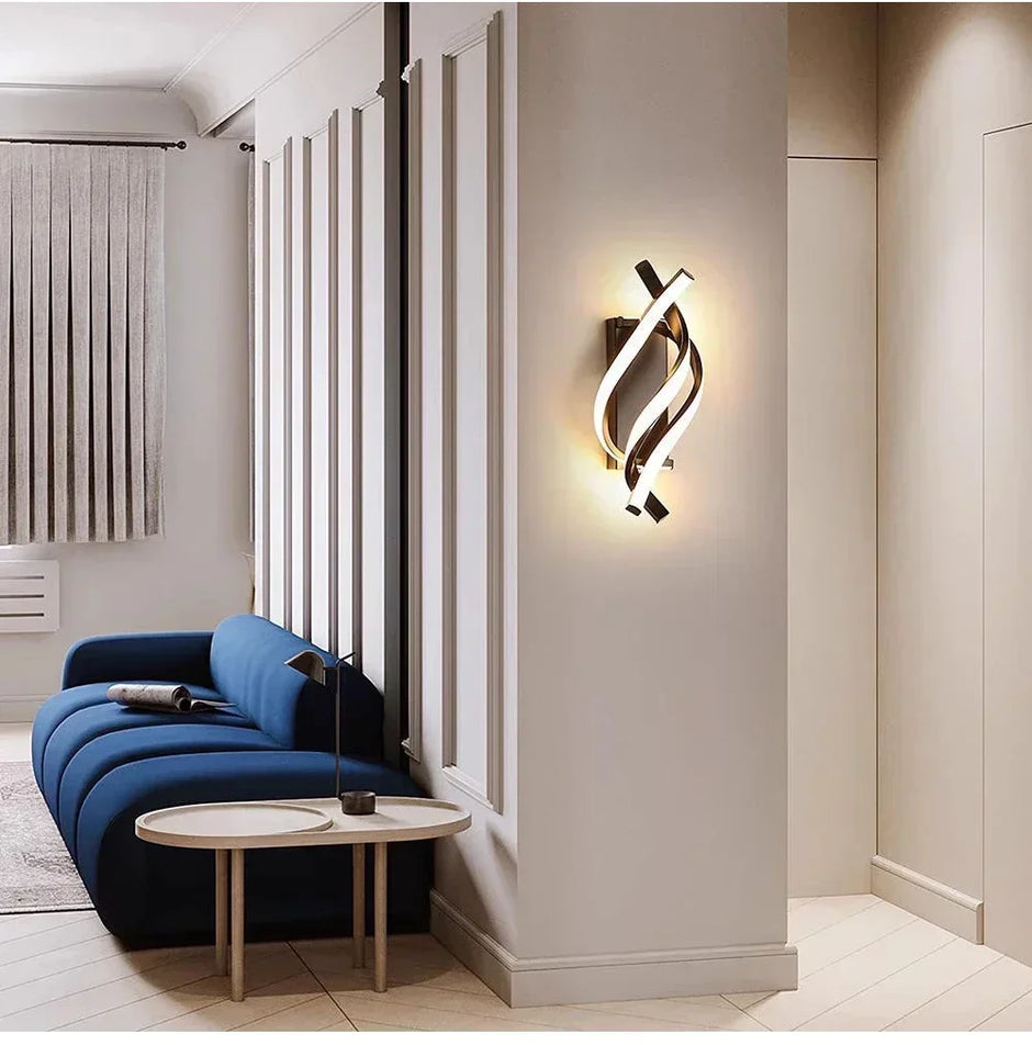 Modern interior design with a blue sofa, round table, and stylish wall light fixture.