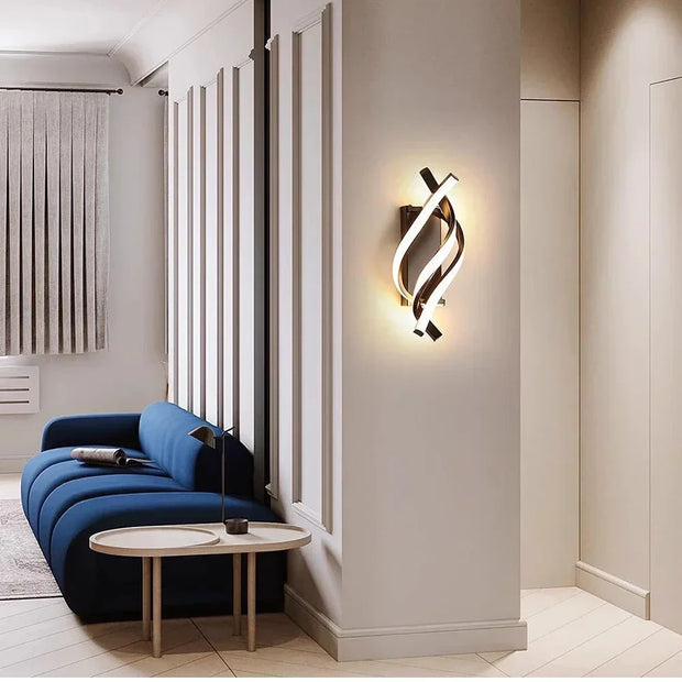 Modern interior design with a blue sofa, round table, and stylish wall light fixture.