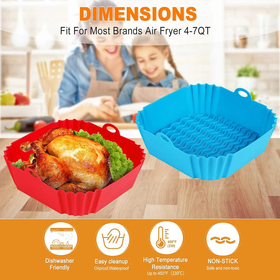 Two silicone baking pans, one red and one blue, with a roasted chicken on a wooden surface. Background shows a kitchen setting with people and food.