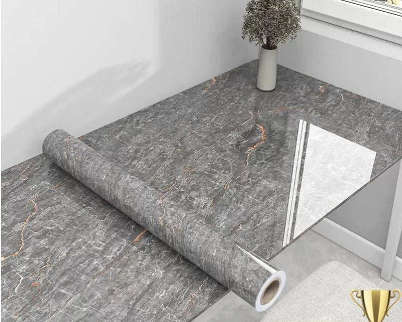 Roll of gray marble-patterned vinyl flooring on a table.