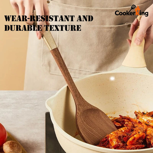 Person cooking with a wooden spoon in a ceramic pot, wearing an apron, on a neutral background.