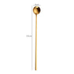 Gold spoon with measurements on a white background