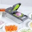 Vegetable chopper with sliced vegetables on a white surface