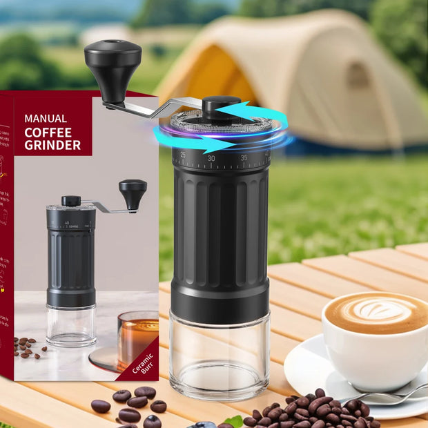 Manual coffee grinder with packaging, coffee beans, and a cup of coffee on a table with a camping background.