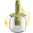 Green kitchen tool with a clear container on a white background