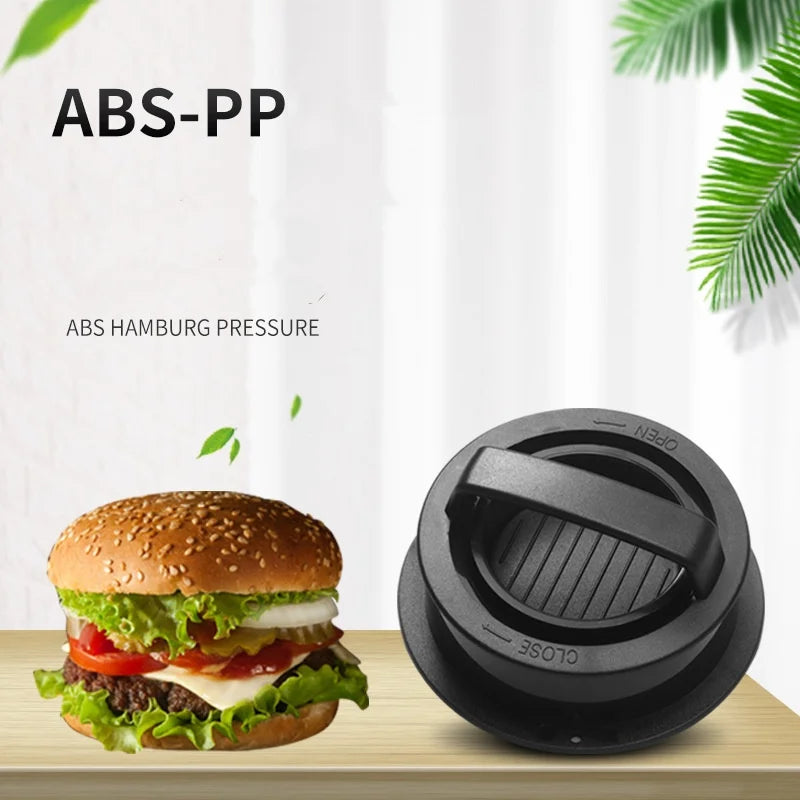 Hamburger press with a hamburger on a wooden surface, against a white curtain background.