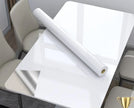 Roll of white paper on a table with chairs in a room setting