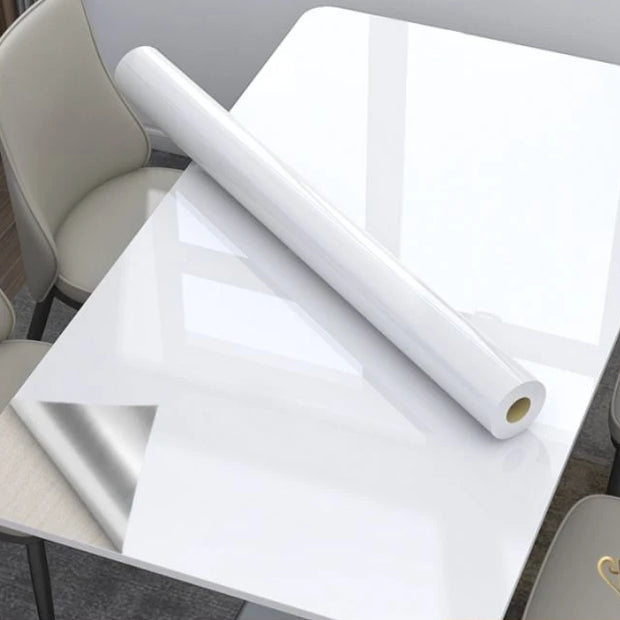 Roll of white paper on a table with chairs in a room setting
