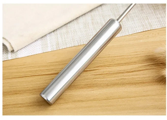 Metallic cylindrical object on a wooden surface
