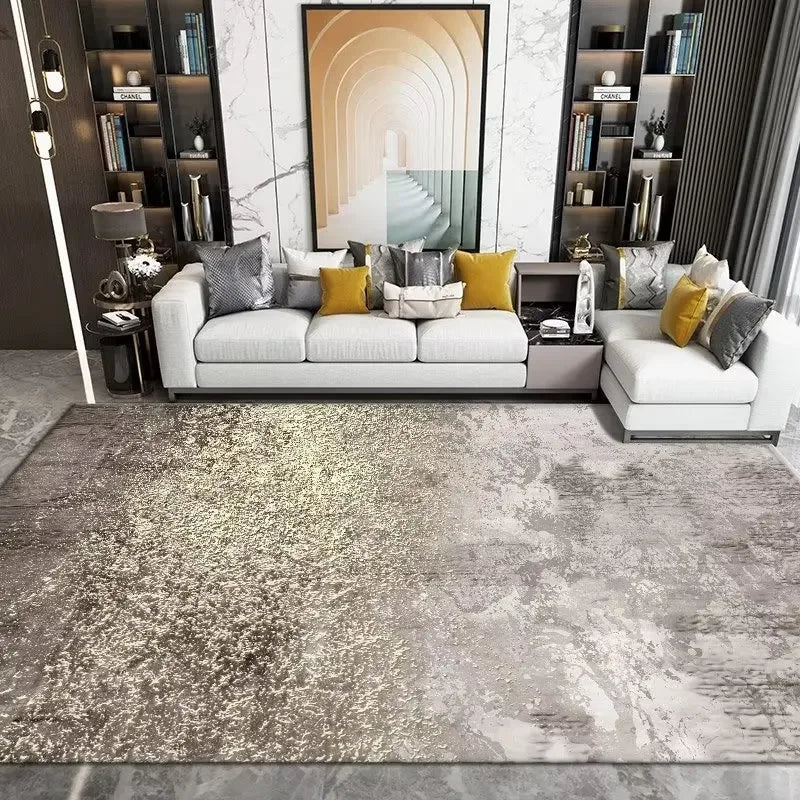 Modern living room with a gray and gold area rug, white sofa, and decorative pillows.