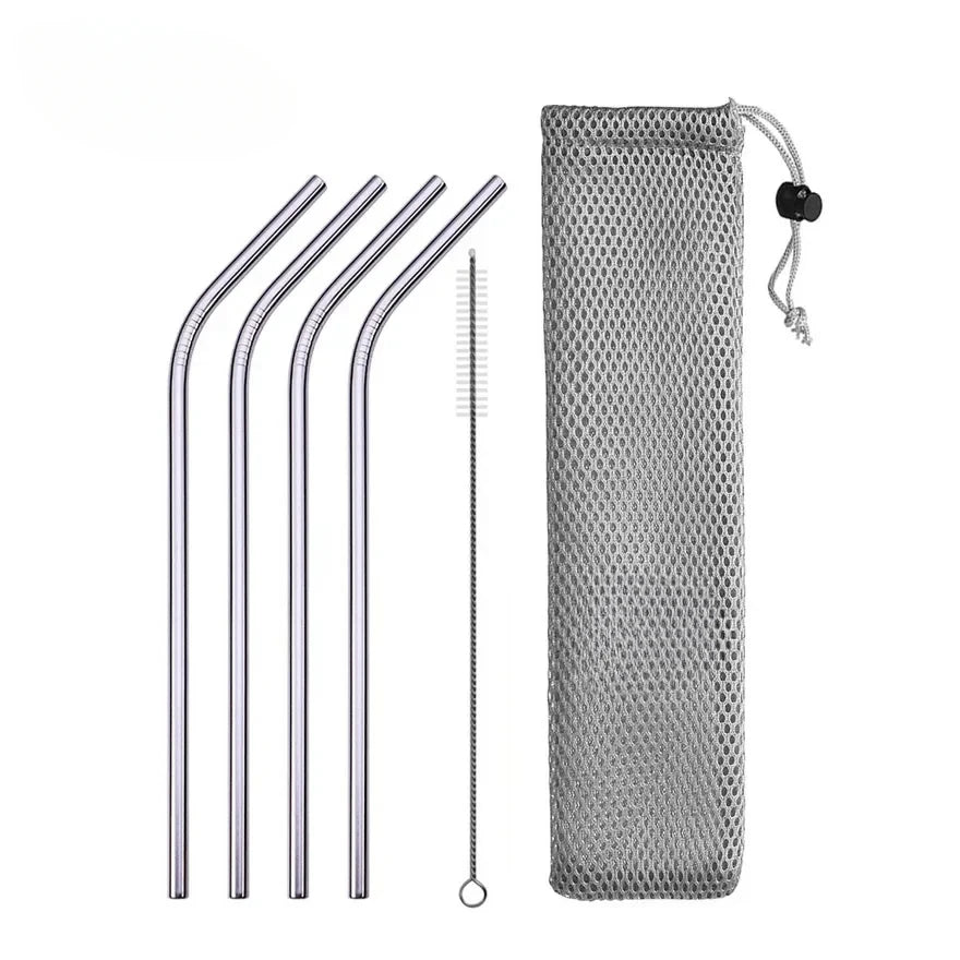 Set of metal straws with cleaning brush and mesh pouch on a white background