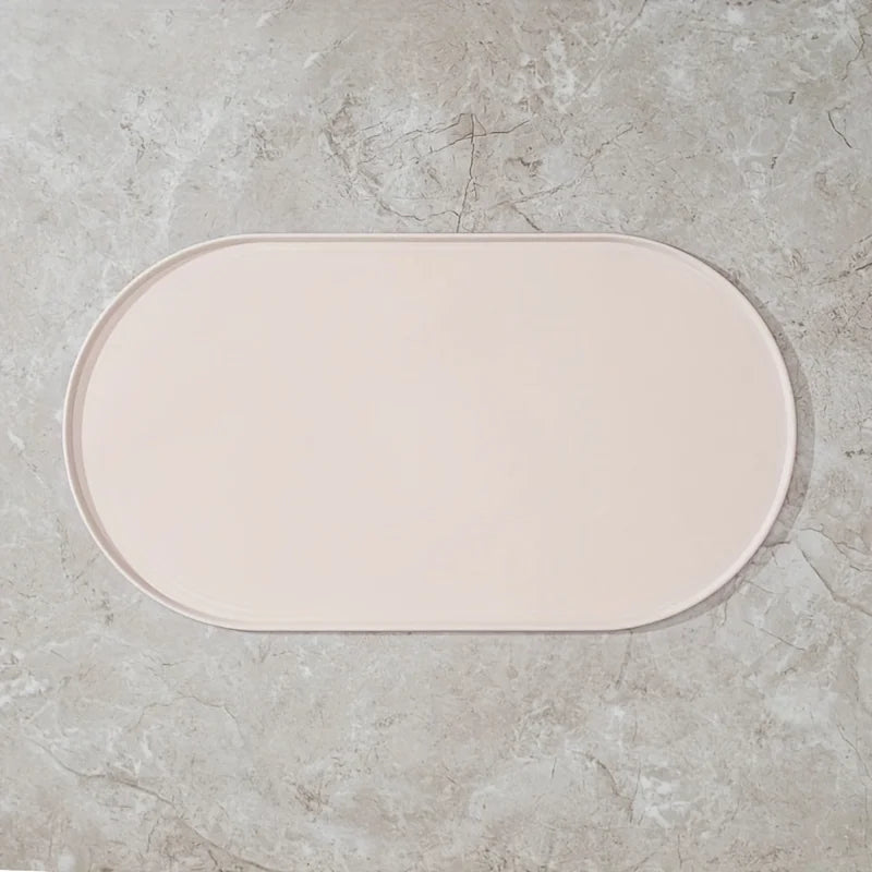 Beige bath mat on a gray concrete floor