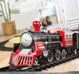 Toy train with red and black engine on tracks in a room setting