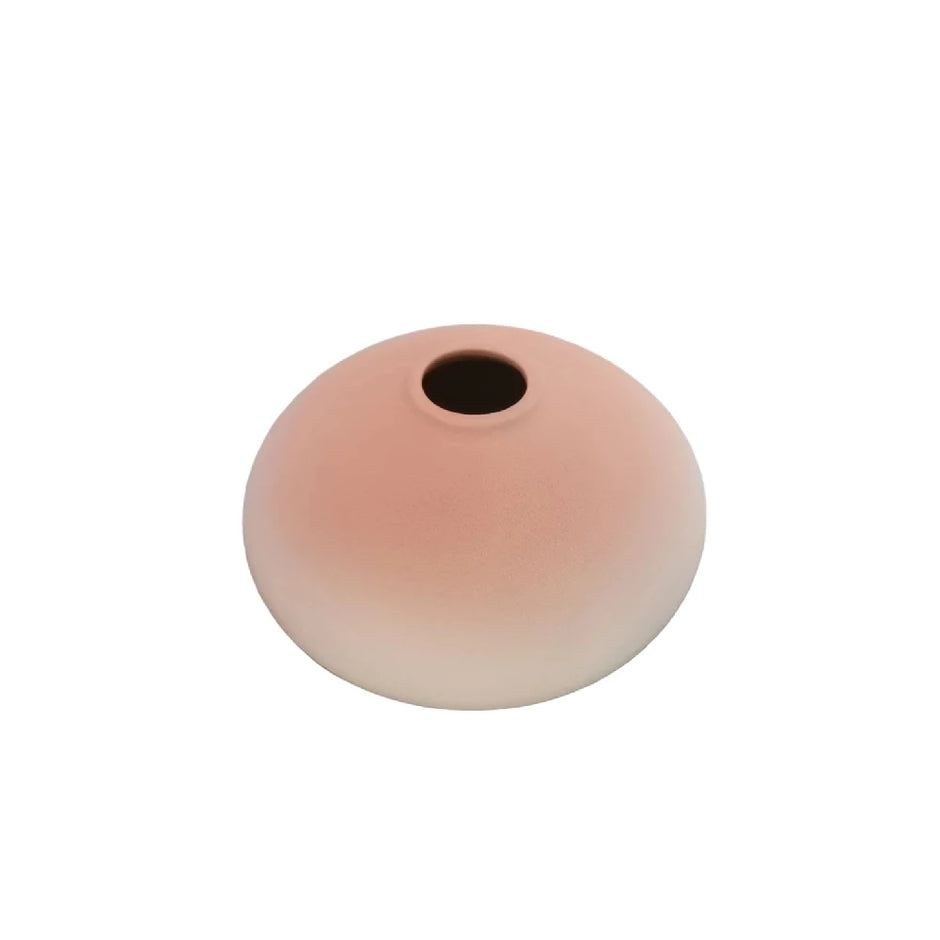 Round beige object with a central hole on a white background