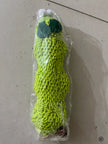 Green textured object wrapped in clear plastic on a light gray surface