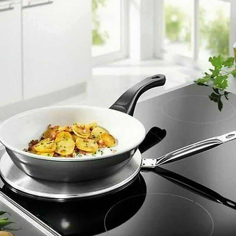 Stainless steel frying pan with food on a stovetop