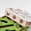 Wooden and green puzzle pieces on a white background