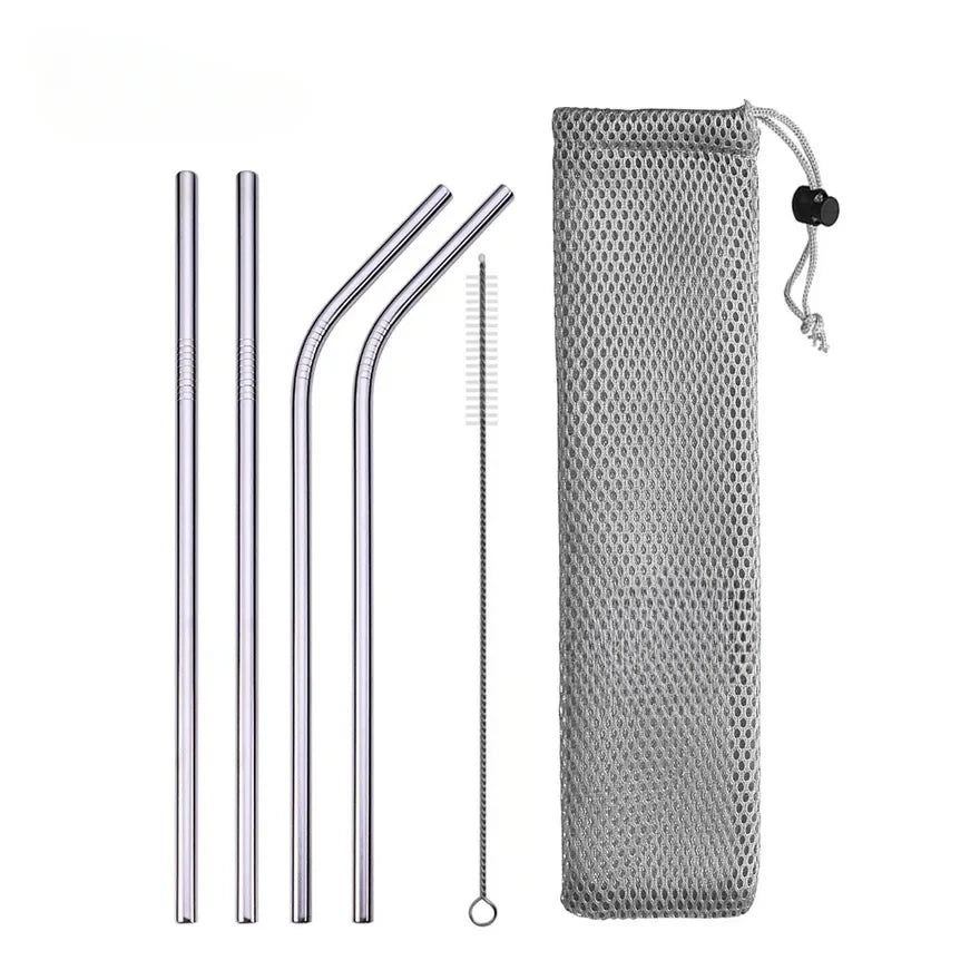 Set of metal straws with cleaning brush and mesh pouch on a white background