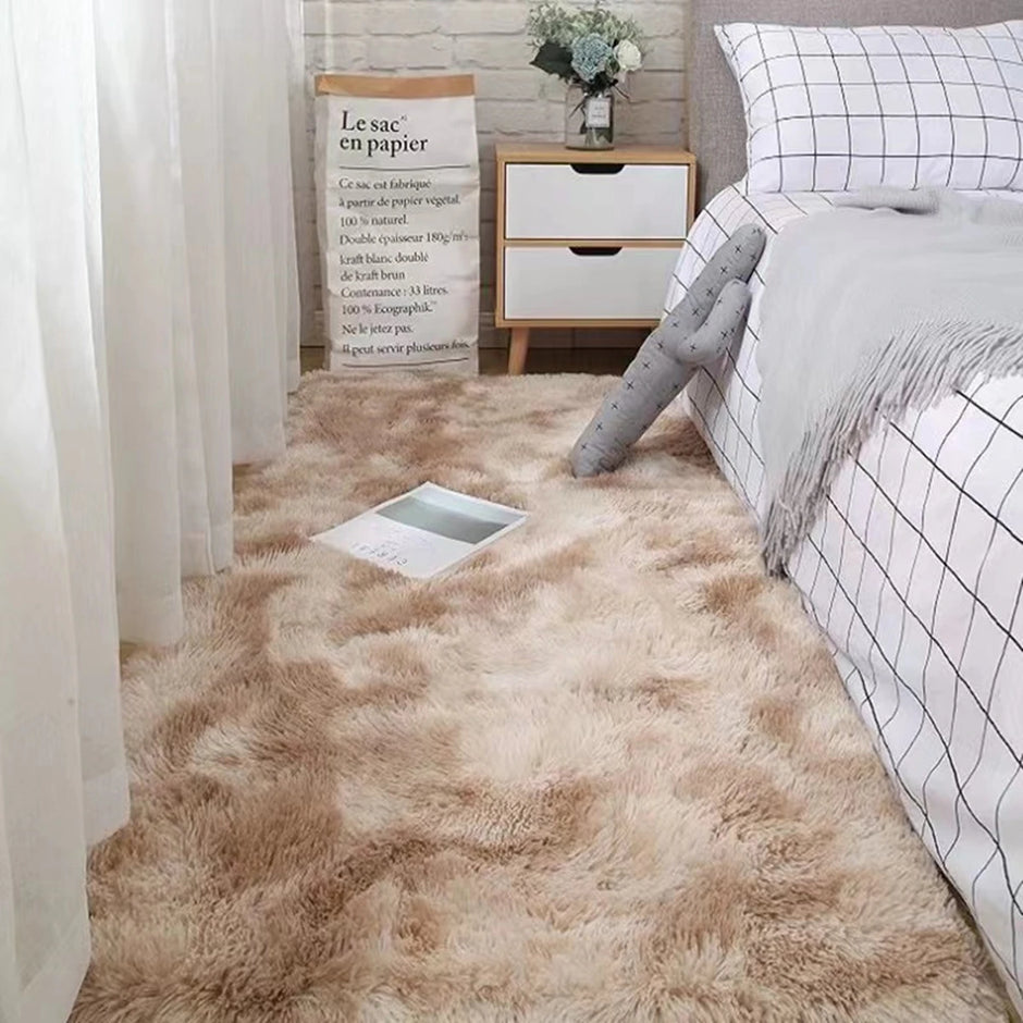 Beige carpet in a bedroom with a bed and nightstand.