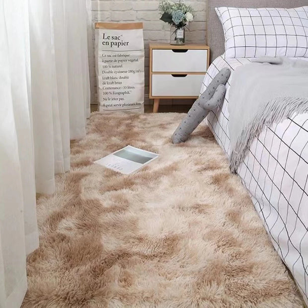 Beige carpet in a bedroom with a bed and nightstand.