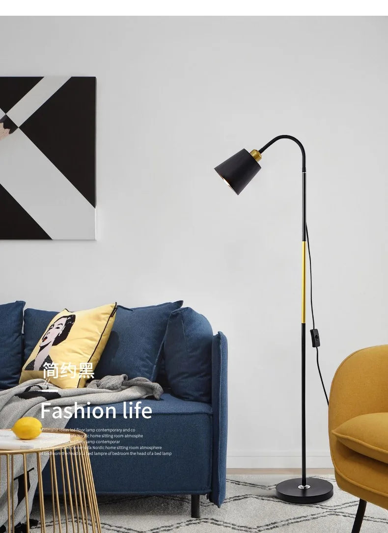 Modern living room with a blue sofa, yellow chair, and standing lamp.