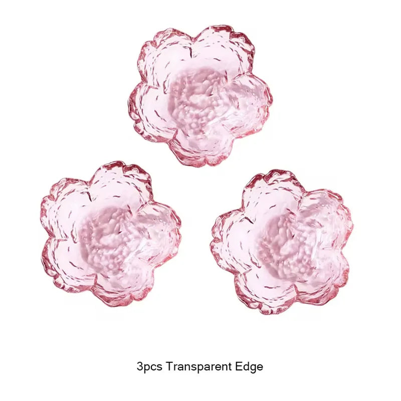 Three pink flower-shaped objects with transparent edges on a white background.