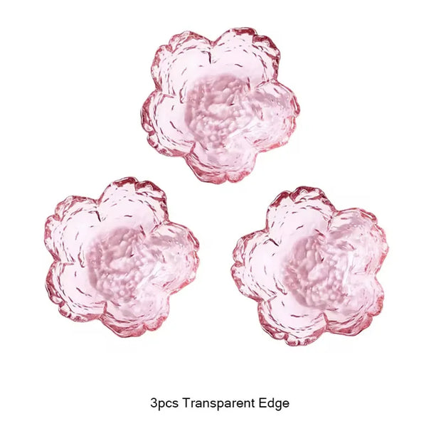 Three pink flower-shaped objects with transparent edges on a white background.