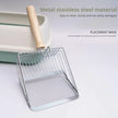 Metallic cat litter scoop with wooden handle on a light gray background