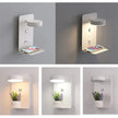 Wall-mounted light fixture with phone charging station and plant holder on a gray background