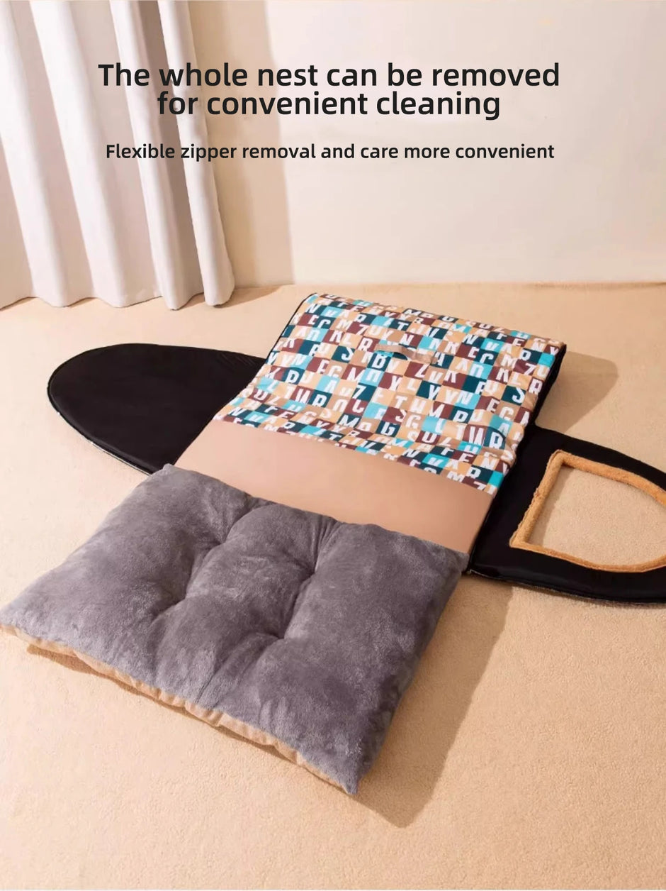 Cat bed with a patterned cover and gray cushion on a beige floor.