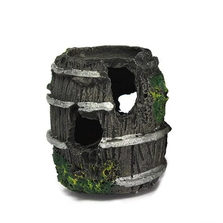 Decorative aquarium rock cave with natural textures and greenery on a white background