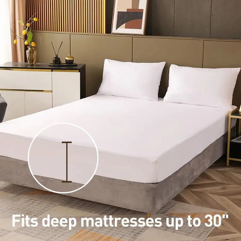 Bed with white mattress cover and pillows in a bedroom setting.