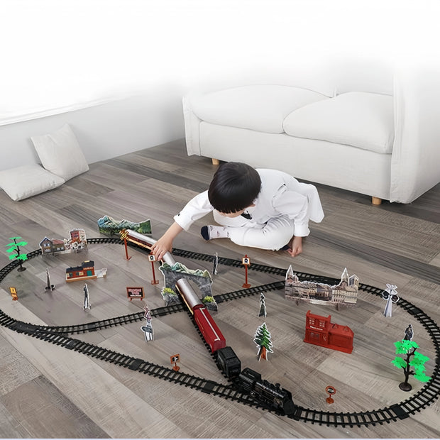Child playing with a toy train set on a wooden floor.