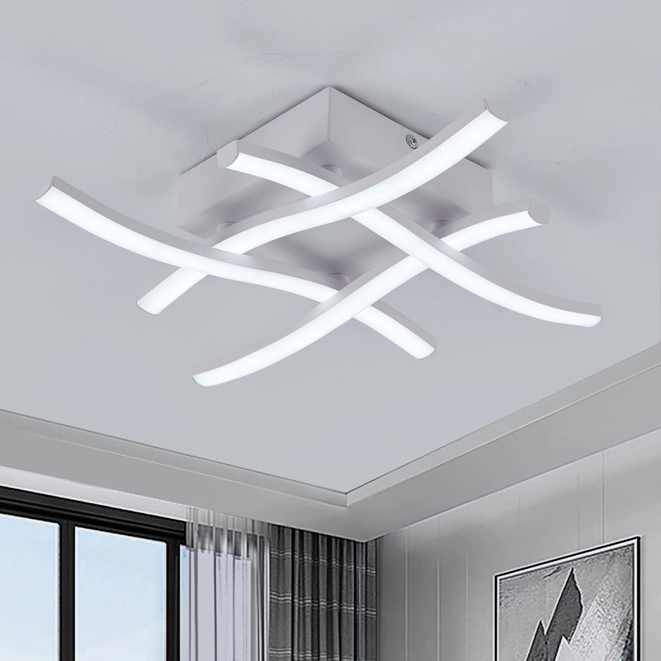 Modern ceiling light fixture in a room with a window and wall art.