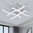 Modern ceiling light fixture in a room with a window and wall art.