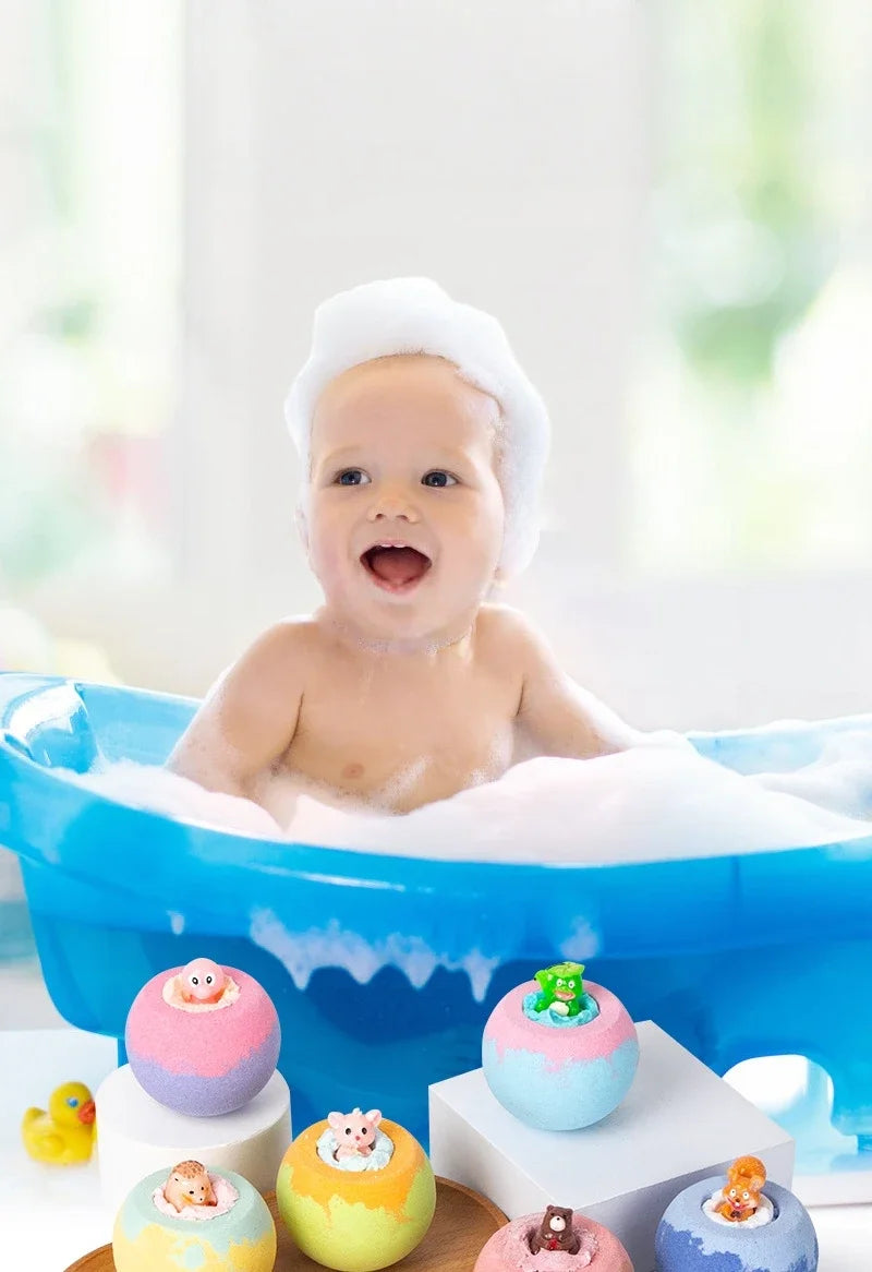 Baby in a bathtub with bubbles and colorful bath toys on a wooden tray.