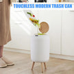 White touchless modern trash can with legs in a kitchen setting