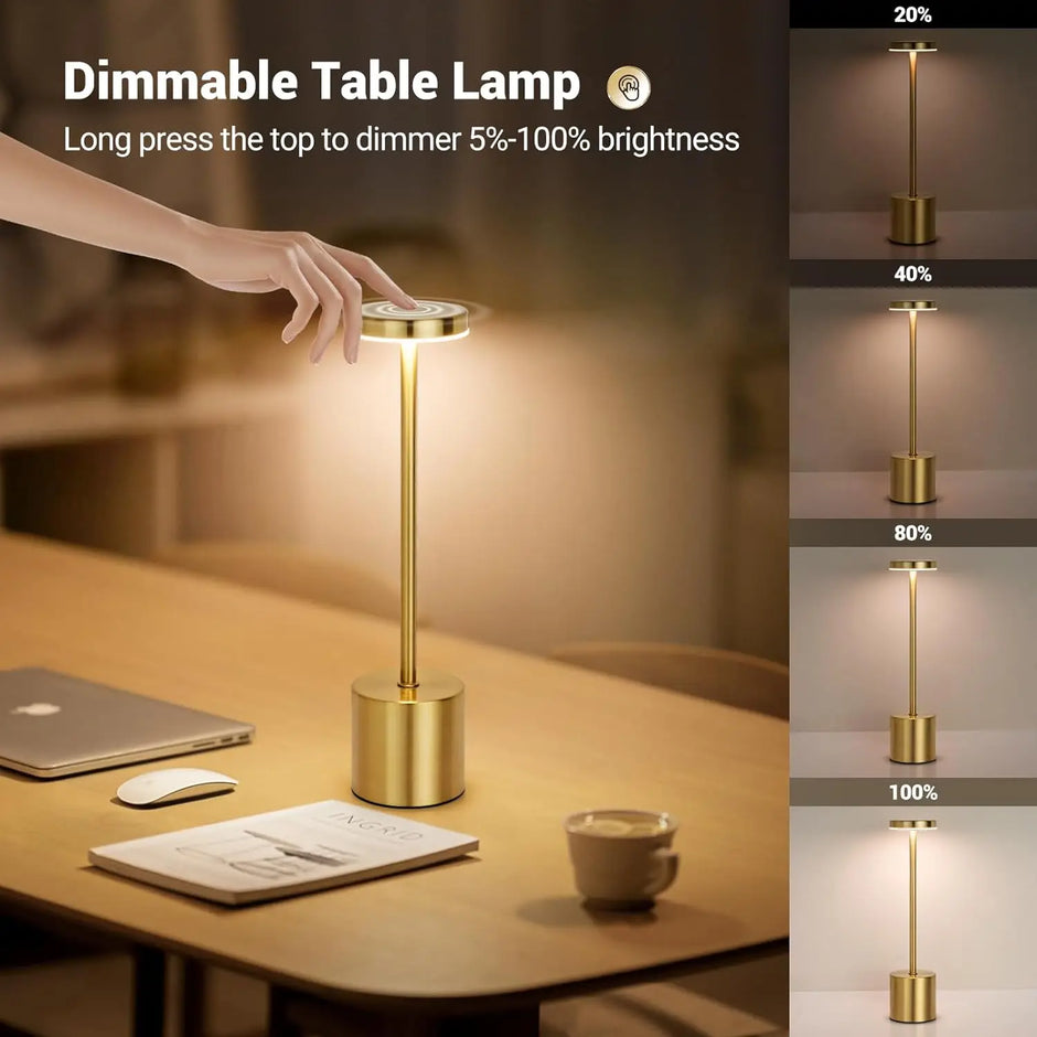 Gold dimmable table lamp on a desk with brightness levels displayed.