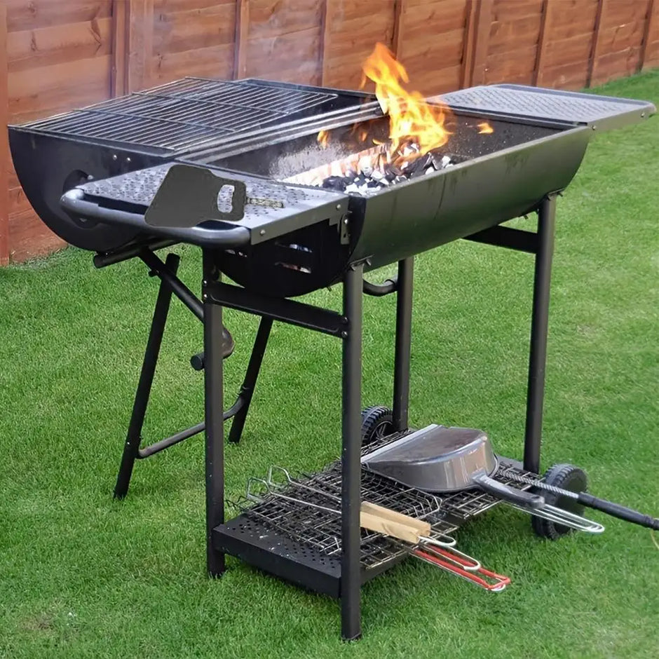 Portable grill with multiple cooking areas on a grassy outdoor setting