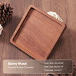 Wooden coaster on a wooden surface with product details.