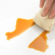 Hand using a beige cloth to wipe an orange substance off a white surface