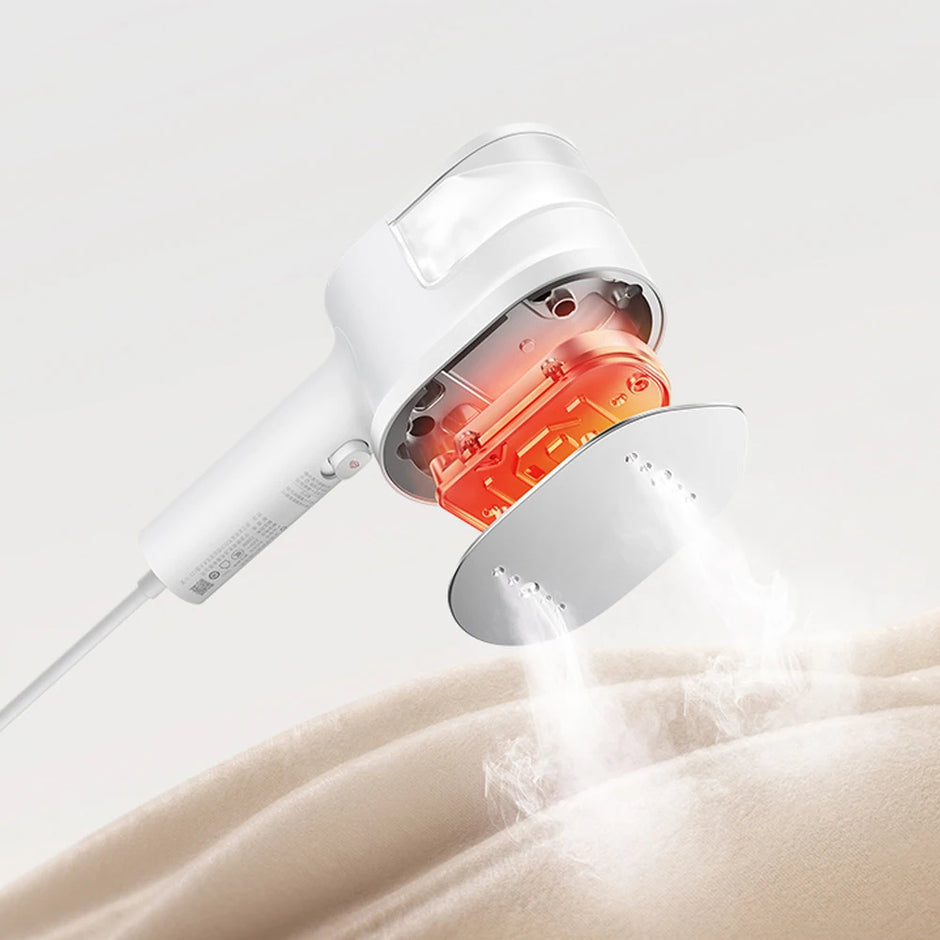 White handheld showerhead with red light emitting onto a beige surface