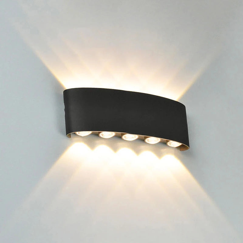 Black wall-mounted outdoor light fixture on a gray background