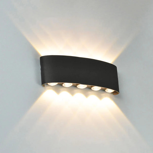 Black wall-mounted outdoor light fixture on a gray background