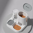 Pet feeding station with food bowls and water dispenser on a gray background