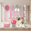 Set of pet grooming tools with a cat sitting below on a white background