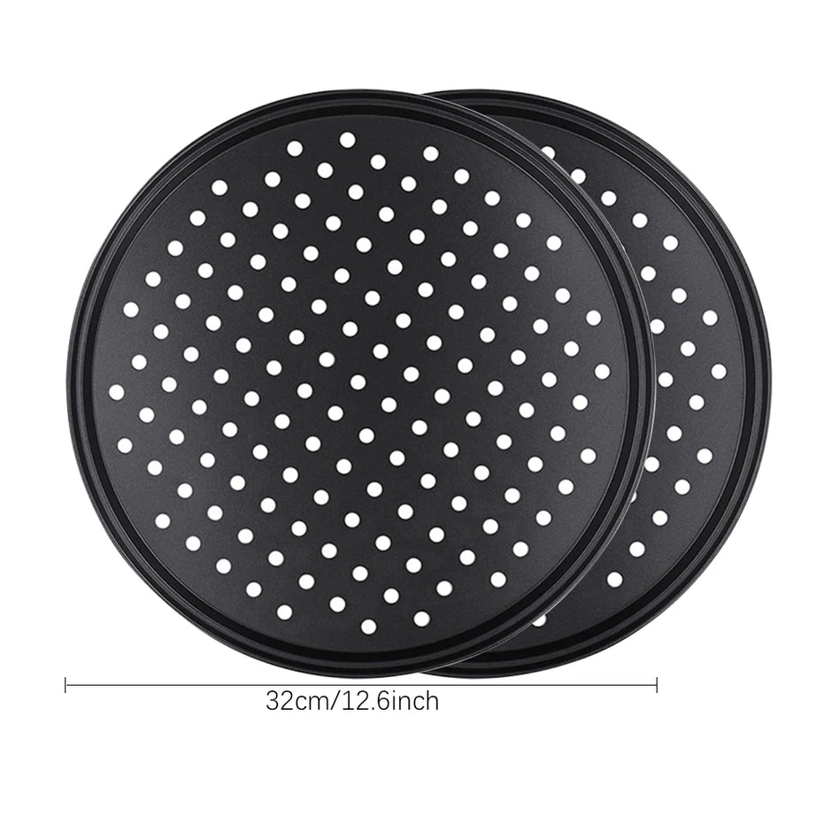 Two black perforated pizza trays with white dots on a white background