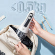 Handheld vacuum cleaner being placed into a bag with '≤0.5kg' text on a light blue background.