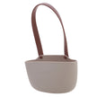 Small beige bucket with a brown handle on a white background